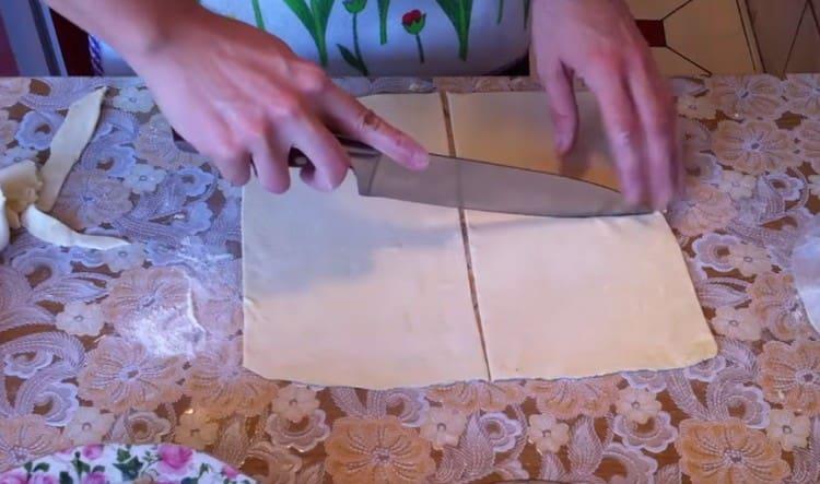 The dough layer is cut into 4 squares.