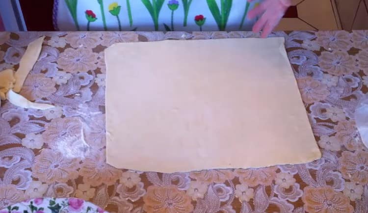 roll out the puff pastry into a square layer.