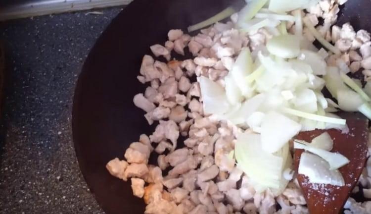 Add the onions to the pan to the chicken.