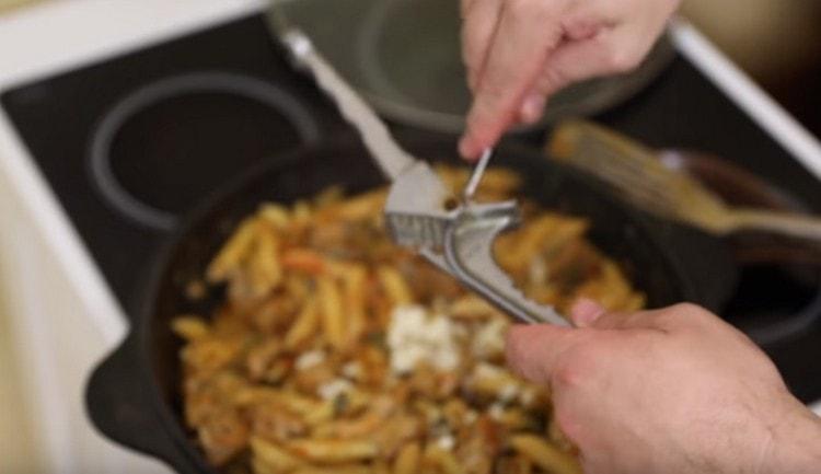 En fin de cuisson, on presse l'ail dans le plat à l'aide d'une presse.