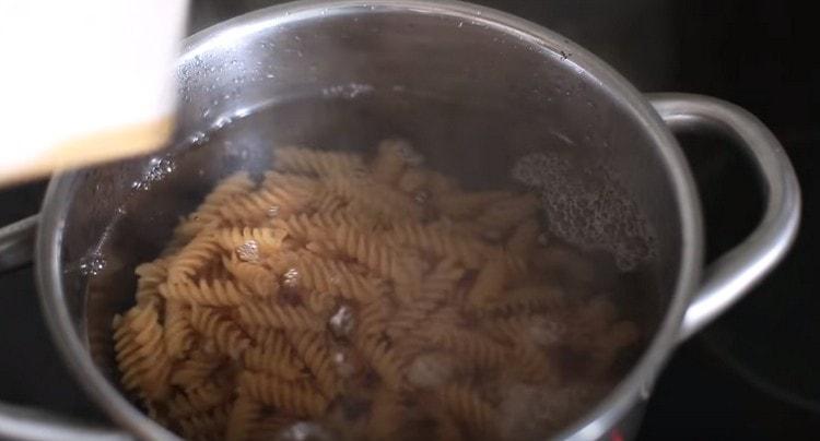 Cook pasta until cooked.