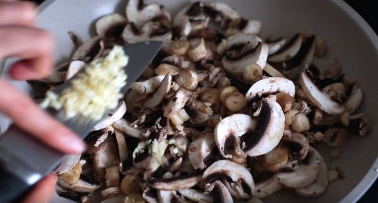 Add garlic to the mushrooms.