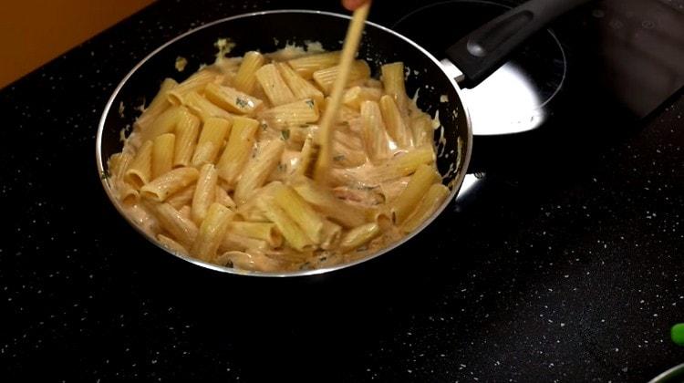 We shift the cooked pasta into the pan.