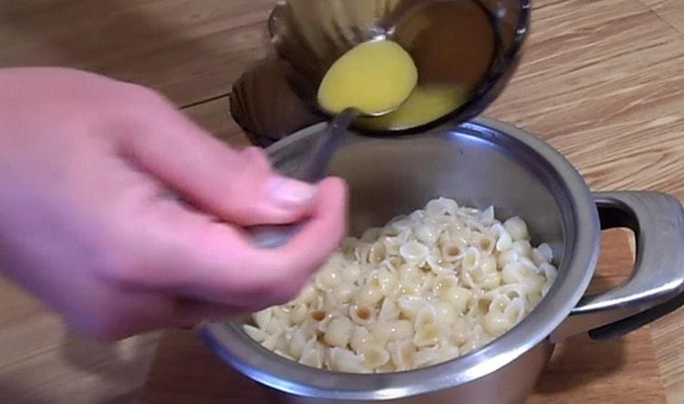 Add the melted butter to the pasta.