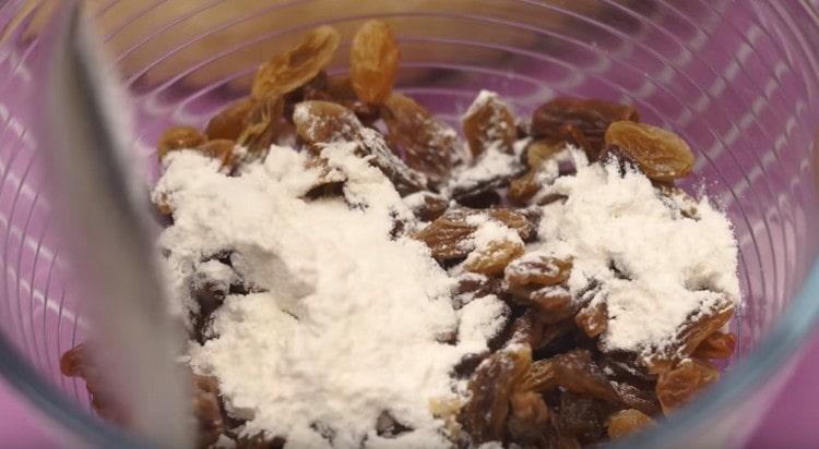 Mix raisins with flour.