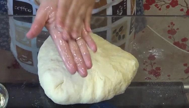 If the dough sticks to your hands, you can grease them with vegetable oil.