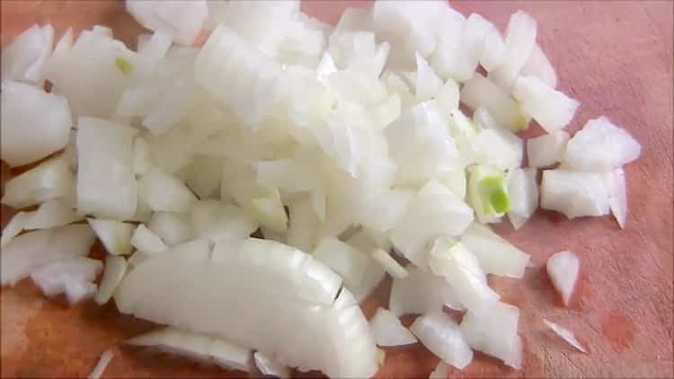 To make rice pies, chop the onion