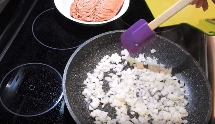 Grind the onion and fry it in a pan until transparent.