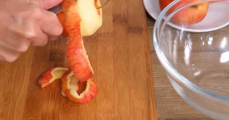 Peel apple to make puff pastry pies with apples
