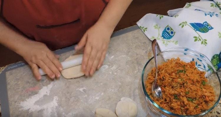 Roll out dough pieces with a rolling pin.