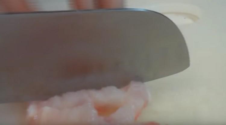 To prepare the filling, finely chop the fish fillet.