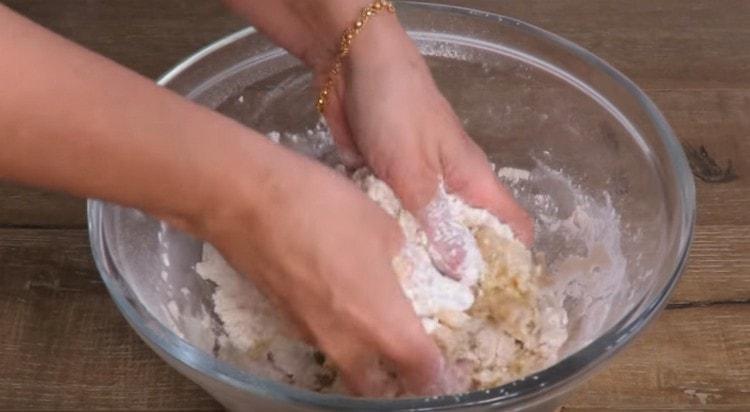 Hands grind flour with vegetable oil.