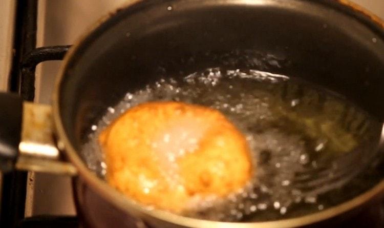 Put the donuts in boiling oil and fry until golden brown.