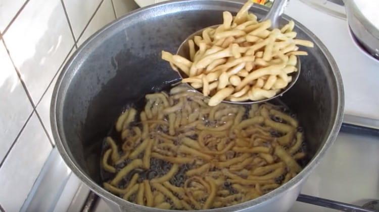 Fry the dough straws in vegetable oil.