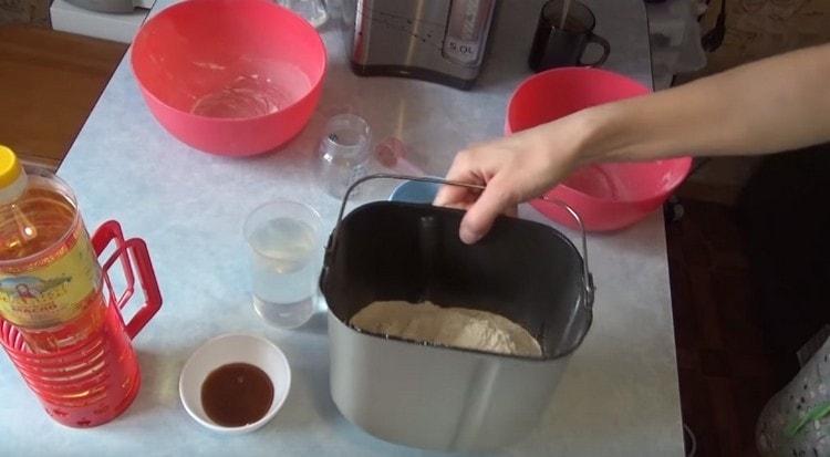 Pour flour into a bucket.