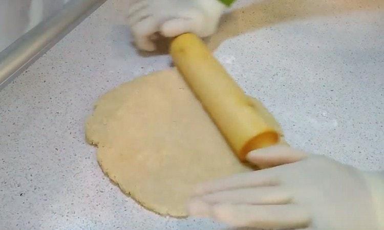 Thinly roll half the dough.