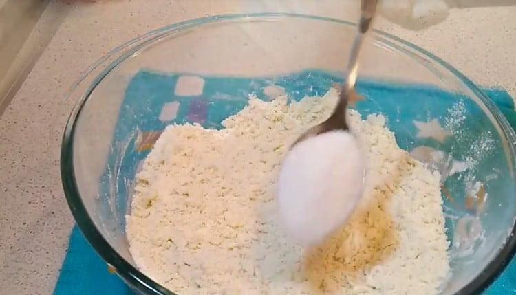 Add sugar to the flour and butter mixture.