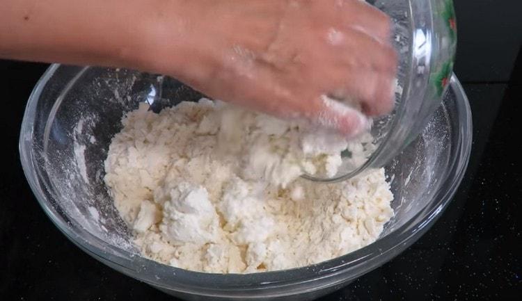 Magdagdag ng cottage cheese sa mga mumo ng mantikilya at harina.