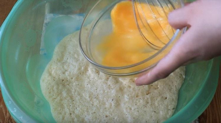 Beat eggs with a whisk and also add to the dough.