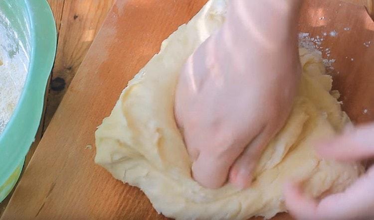 Knead the dough on a floured work surface.