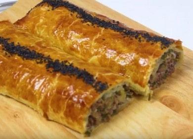 Delicious roll of puff pastry with minced meat and herbs