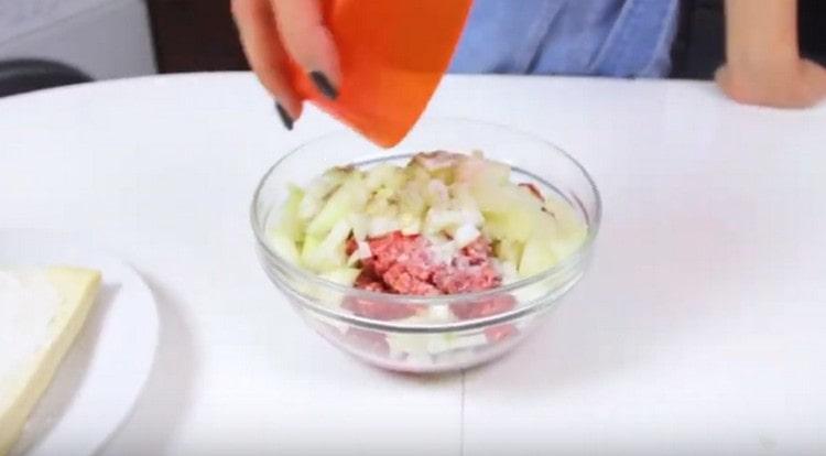 Add the chopped onion to the minced meat, salt, and pepper.