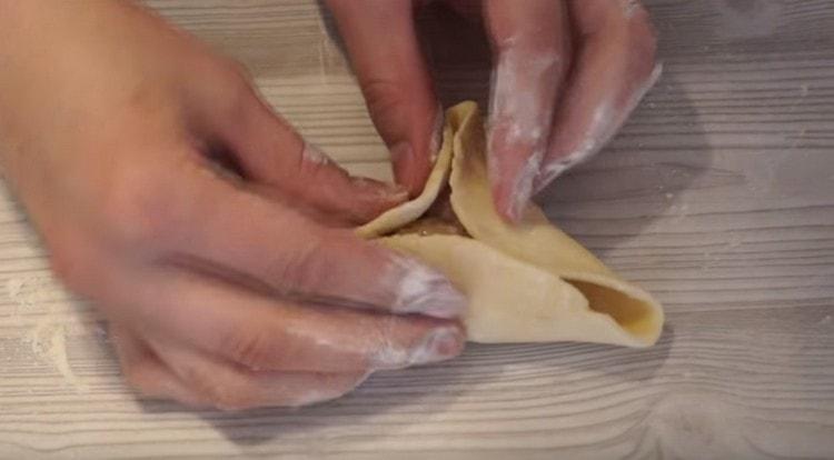 Nous connectons les bords de la pâte, formant une tarte triangulaire.