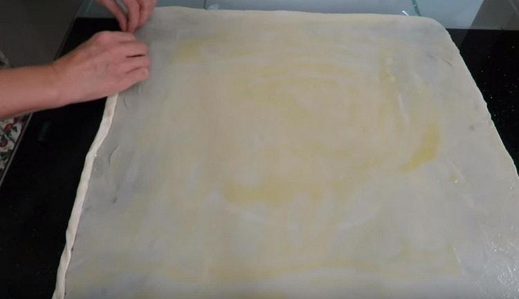 Gently roll the oiled dough into a tight roll.