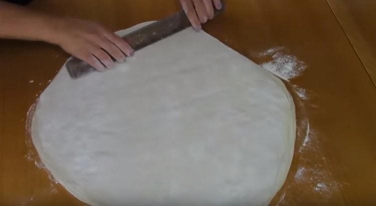 Then the dough needs to be rolled thinly with a rolling pin.