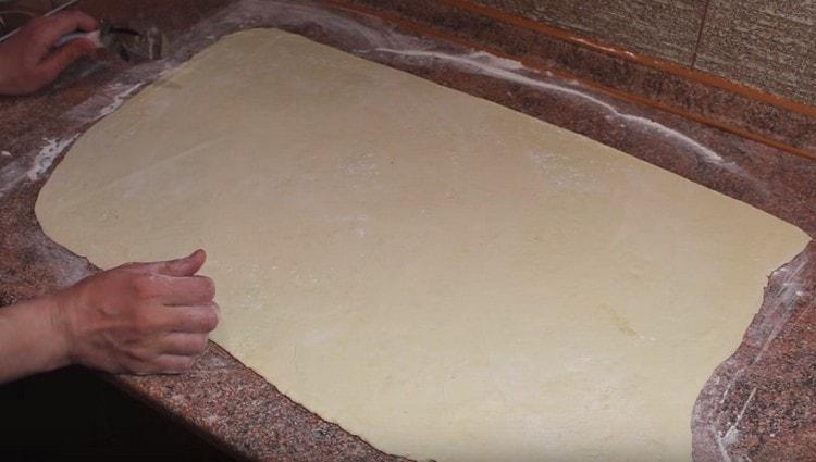 Roll the puff pastry thinly into a large rectangle.