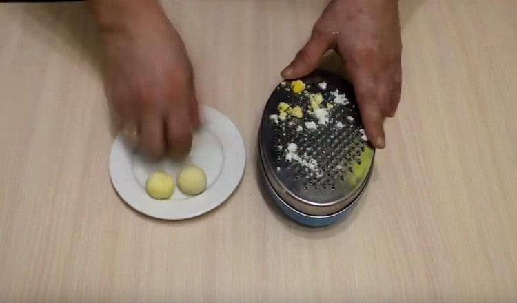 Rub on a fine grater hard-boiled eggs.