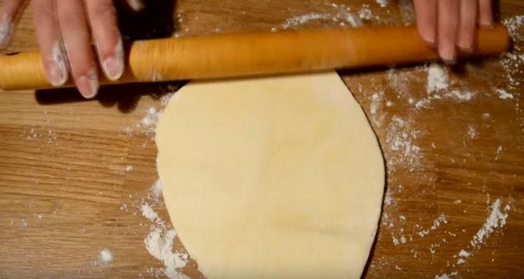 We roll each part of the dough into a circle.