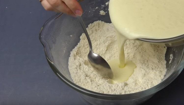 Add liquid components to the flour and oil mixture.