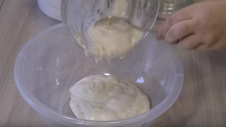 We shift the rising dough into a larger bowl.