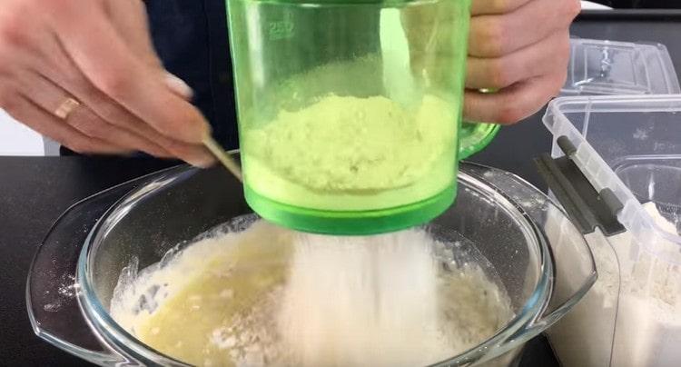 After mixing the flour with dry yeast, sift it to milk with butter.
