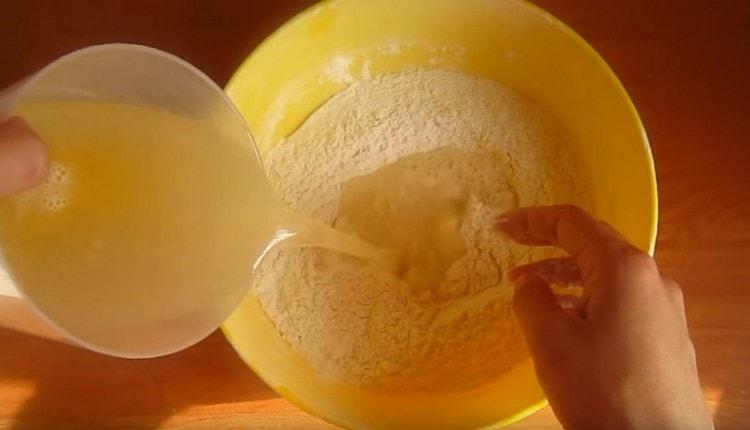 A mixture of liquid components is poured into sifted flour.