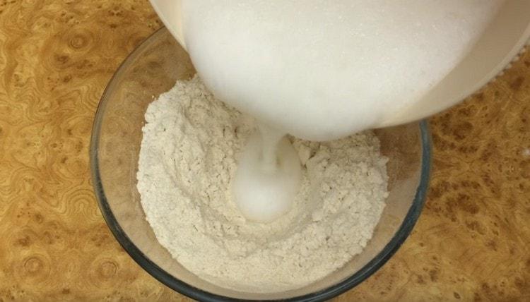 Lush white foam is introduced into pre-sifted flour.