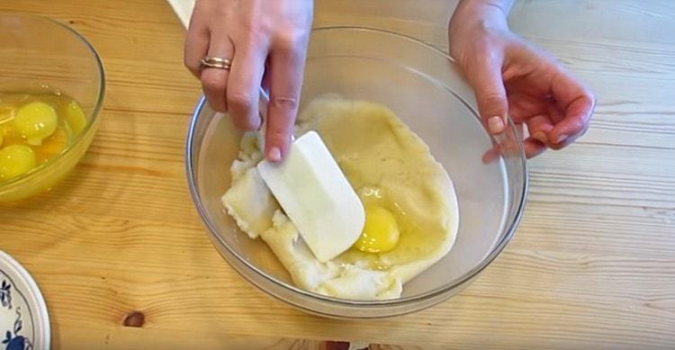 One at a time, begin to mix the eggs into the dough.