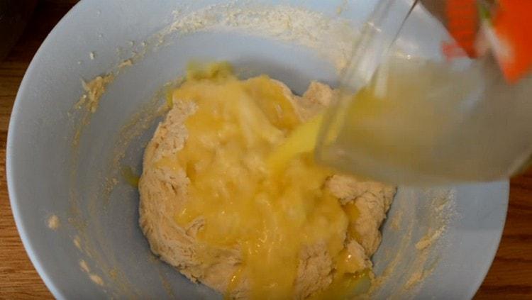 Kad se tijesto skupi u još ljepljivu kvržicu, dodajte rastopljeni maslac.