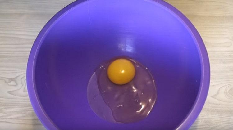We beat one egg into a deep bowl.