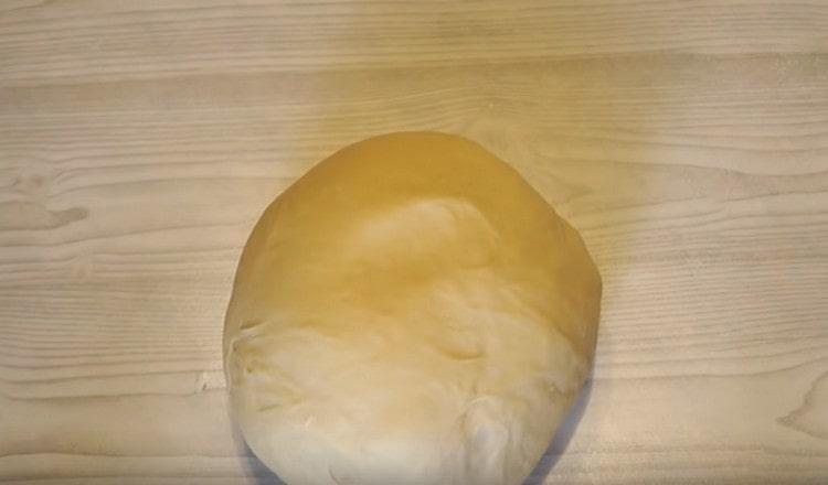 Next, the dough needs to be well kneaded on the work surface to get a smooth elastic mass.