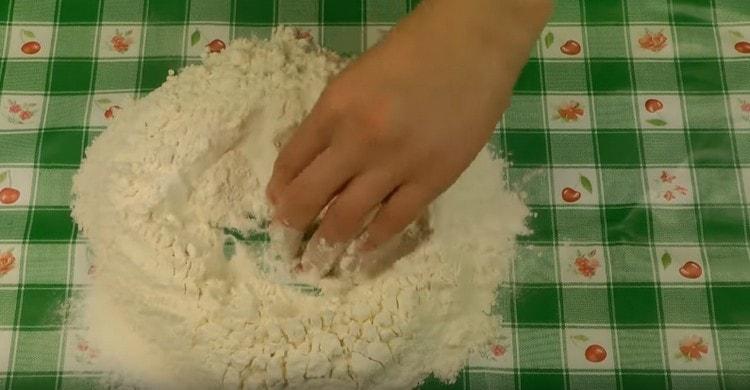 We make a depression in the flour.