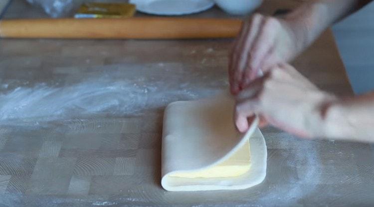 We spread the butter on one half of the dough and cover it with the second half.