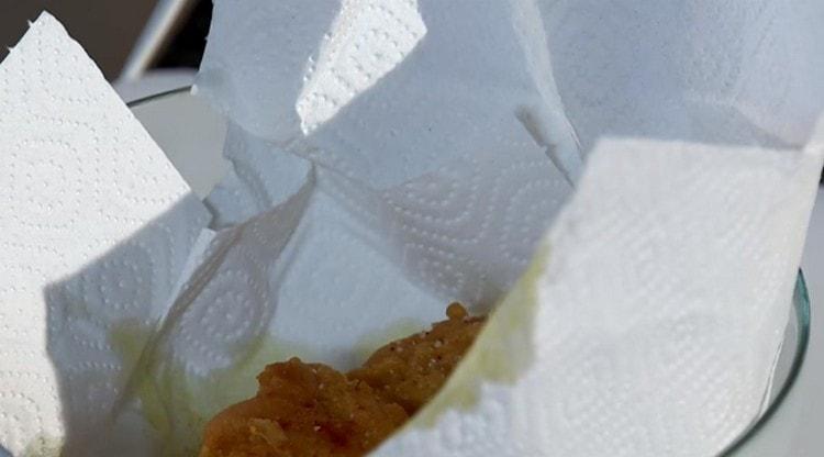 Pon los trozos de pescado frito sobre toallas de papel.