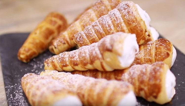 Puff pastry rolls with protein cream can be sprinkled with powdered sugar.