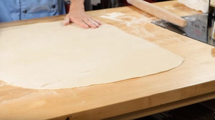 Roll out each part of the dough as thin as possible.