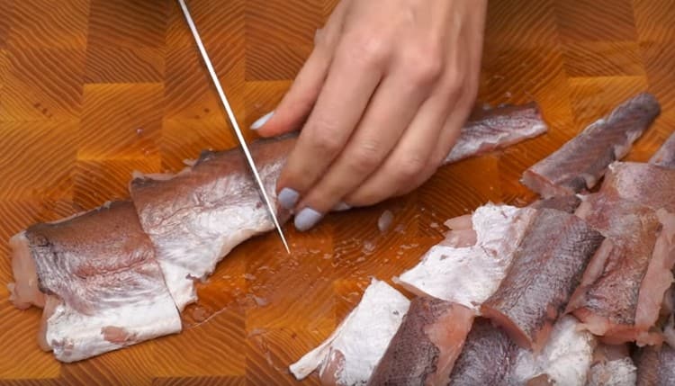 We clean and cut the hake fillet into portioned pieces.