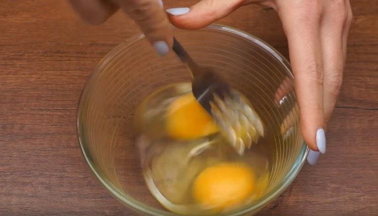 In a bowl, beat two eggs lightly.