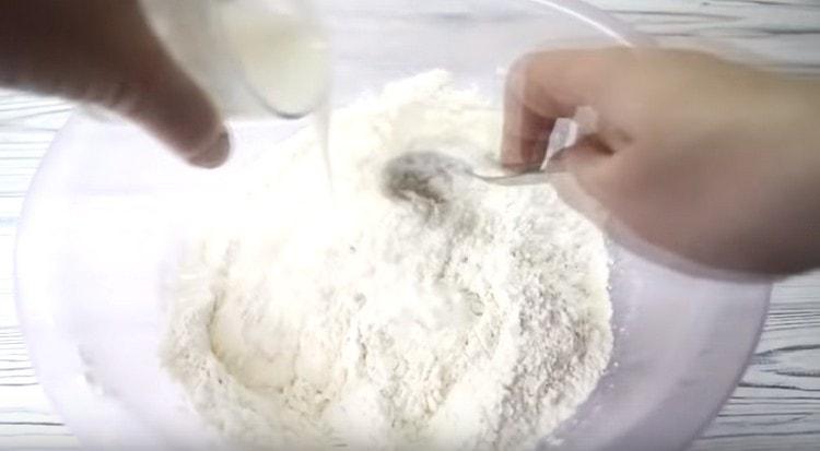 Add kefir to the dry ingredients and knead the dough.