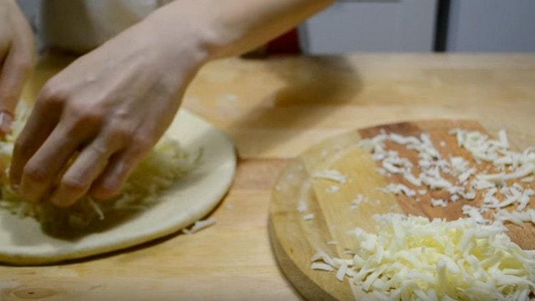 We spread almost the whole cheese on the center of the dough.
